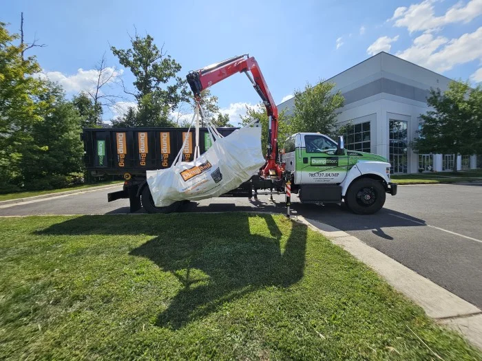 pivot arm loading a dumpbag